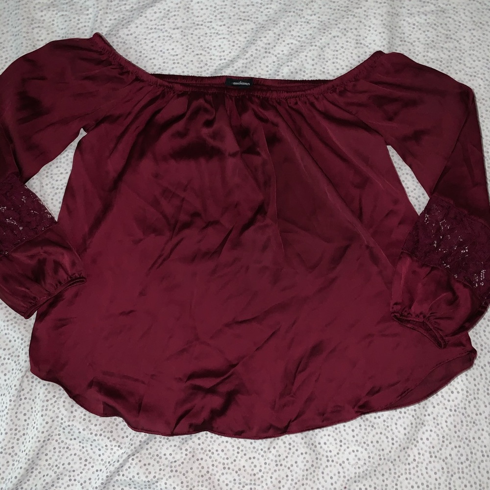 This is a burgundy red, satin, off-shoulder top